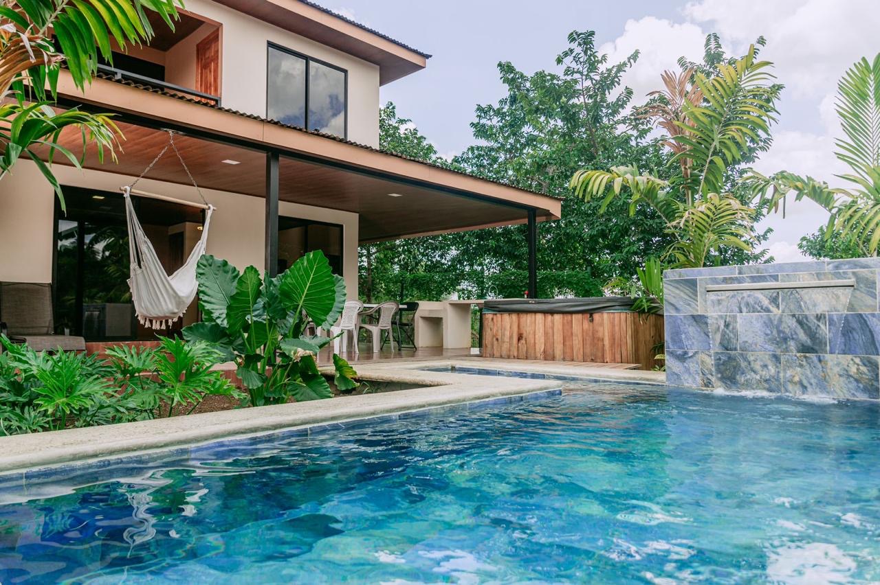 Exterior view of home with pool, hammock, and jacuzzi in Chachagua, Costa Rica