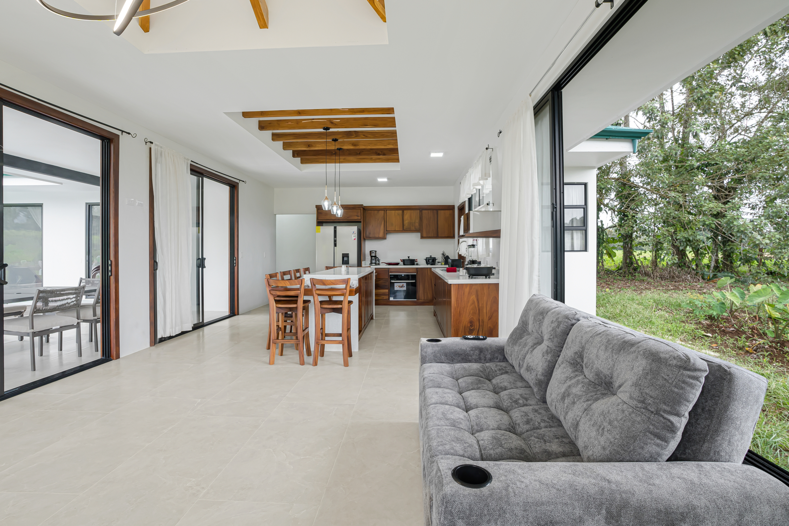 Open-concept living room and kitchen with island, home in La Fortuna, Costa Rica