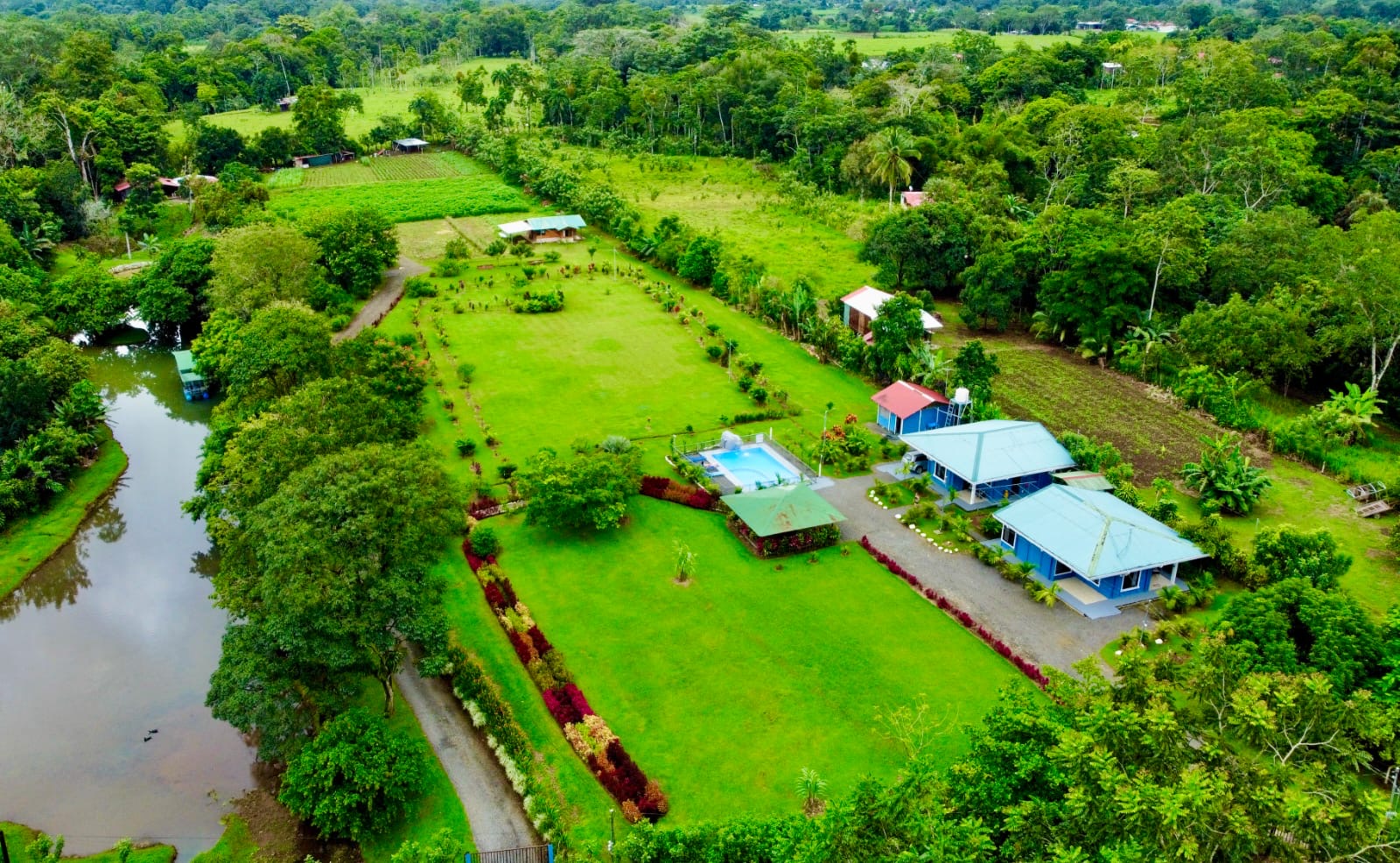 Aerial view of the multi-home investment property with pool, houses, and rancho near La Fortuna, Costa Rica