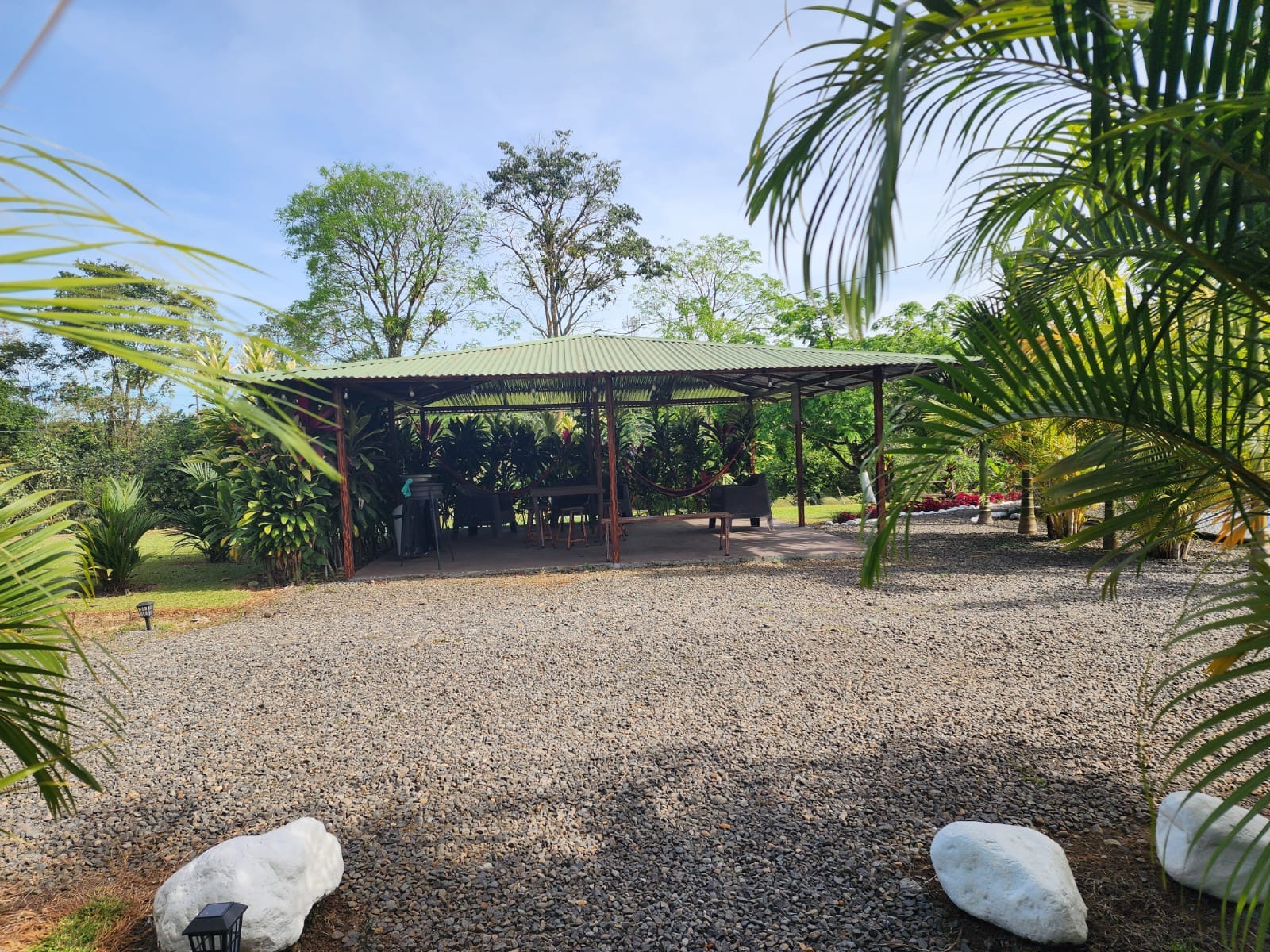 Covered rancho with hammocks and seating area at the multi-home property near La Fortuna, Costa Rica