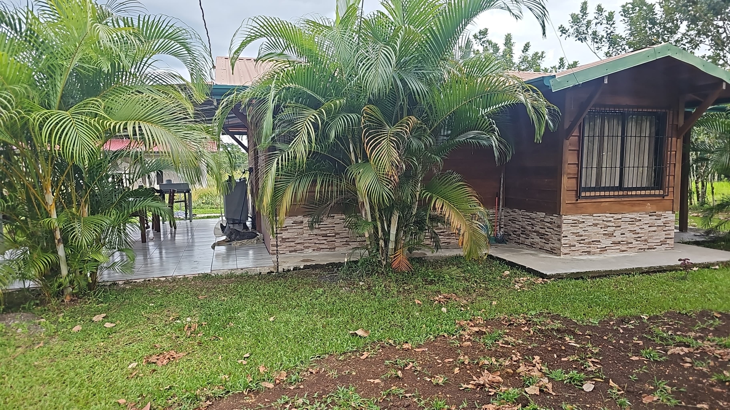 Rustic wooden home with covered terrace at the multi-home investment property near La Fortuna, Costa Rica